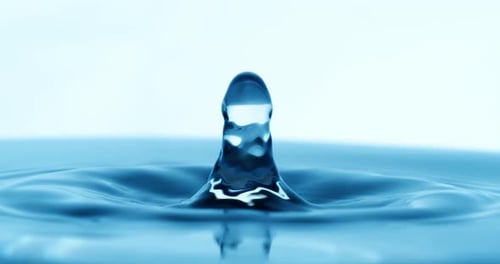 Drop of water falls into a drop of water in a super slow motion. Shot on super slow motion 1600 fps.