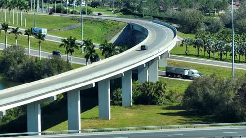 Freeway Exit Junction Over Road Lanes with Fast Moving Traffic Cars and Trucks Interstate