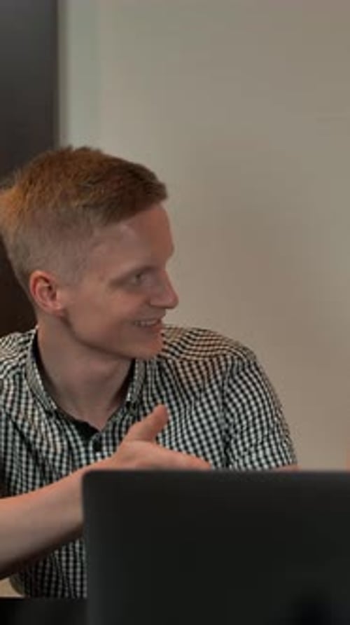 Colleagues Discussing Work at Modern Office Desk