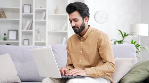 Man Working on Laptop Computer at Home