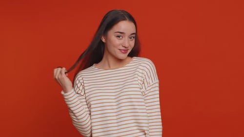 Attractive Woman Smiles and Twirls Her Hair