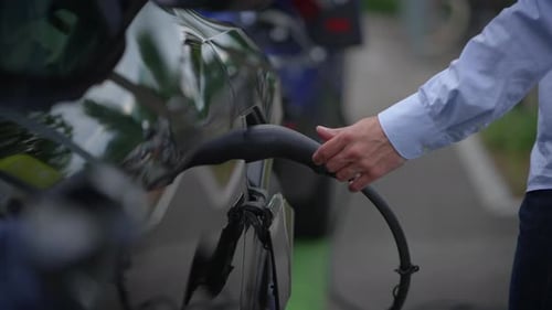 A Detailed CloseUp View of an Electric Vehicle Charging Station Set in an Urban Environment