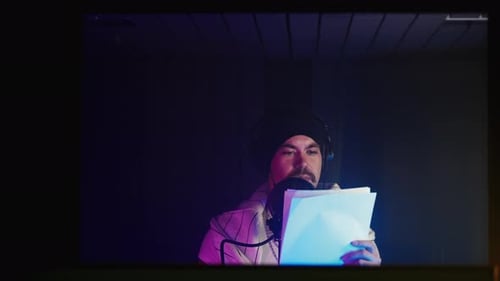 Professional Voice Actor Man is Recording Audiobook or Podcast Portrait with Mic in Record Studio