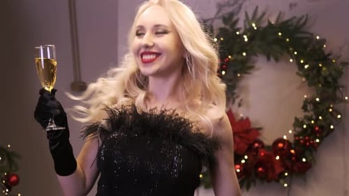 Woman Celebrates Christmas, Drinks Champagne and Dances