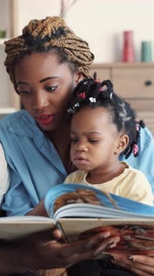 Loving Family Reading a Book Together Indoors