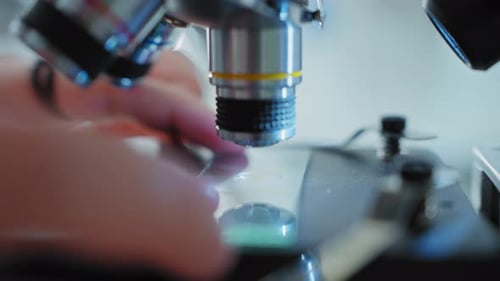 Scientist Using Microscope For Medical Research in Lab