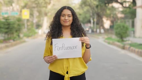Young Adult Holding Influencer Sign on Street