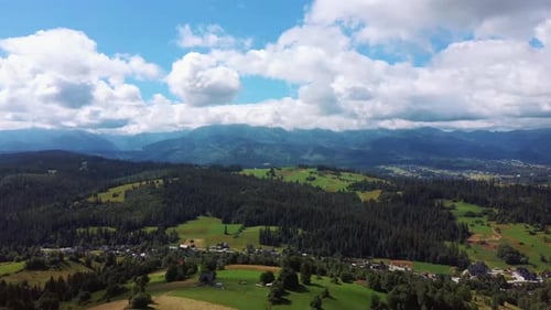 Aerial Shot in Alpine Village Epic Mountain Peaks, Hills Covered With Pine Trees in Haze, Sunrise Li