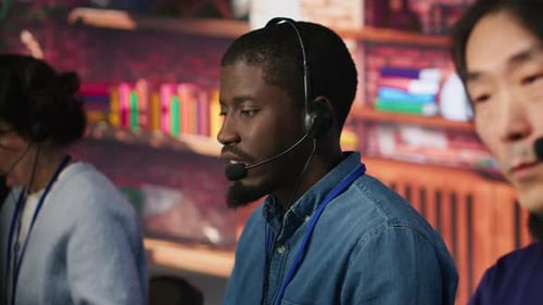 Team of Multiethnic Call Center Agents in Workplace Helping Customers