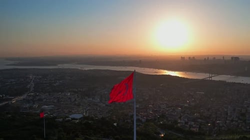 Aerial View of Cityscape at Sunrise with Flags