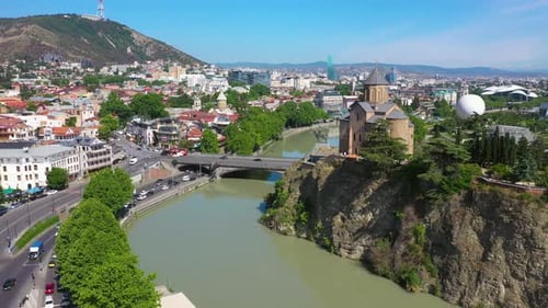Aerial shot of Tbilisi city, river Kura and Metekhi Church in Georgia