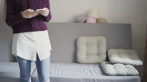 Woman Using Phone in Home Interior