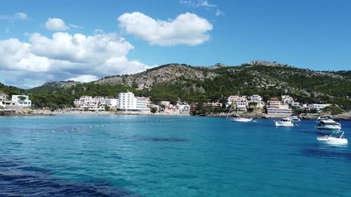 Steady 4 K Drone footage onto a quiet Mallorca Spain Coast line with beaches Hotels boats blue water