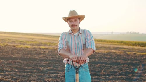 Adult Caucasian Smiling Men Wearing Hat Posing to the Camera at the Field Smart Livestock Farming