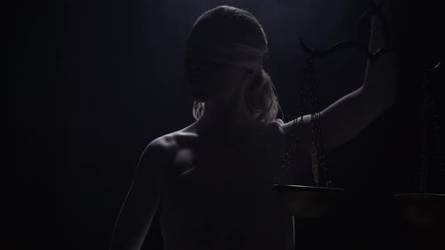 Dramatic Lady Justice Statue Holding Scales in Studio