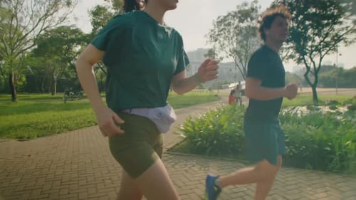 Sporty Couple Jogging Outdoors in Morning
