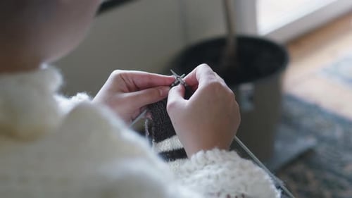 Close Up of a Woman Knitting with Yarn