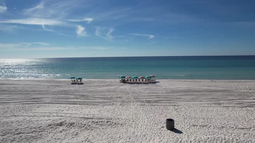 Beach Umbrellas And Chairs On The Sand In Panama City Beach, Bay County, Florida. wide drone shot