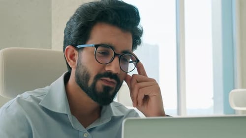 Pensive Indian Arabian Muslim Business Man CEO Thinking Office Laptop Planning Solution Looking Away