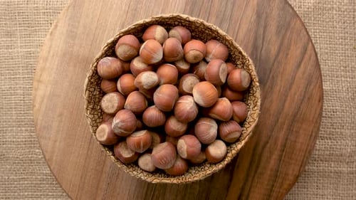 Fresh Hazelnuts in Basket on Wooden Surface