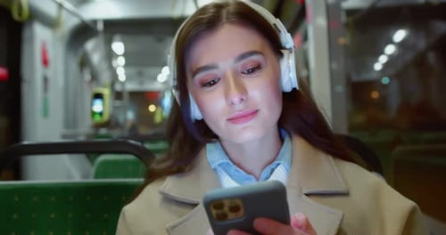 Woman Listens To Music on Train at Night