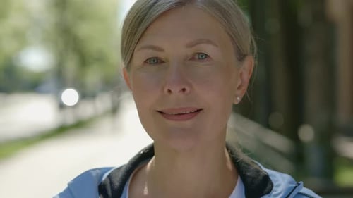 Portrait of the Beautiful Smiled Mature Woman Looking at the Camera Before the Training