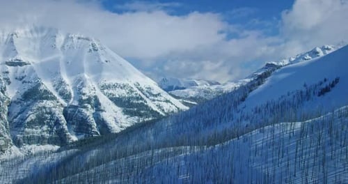 Snowy mountain range in Banff National Park, wide aerial