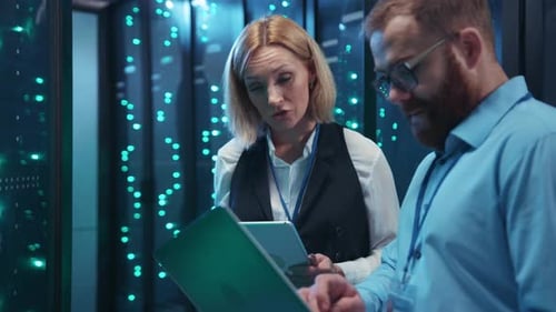 IT Professionals Inspecting Servers in Data Center