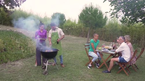 Friends Enjoying a Summer Barbecue Outdoors