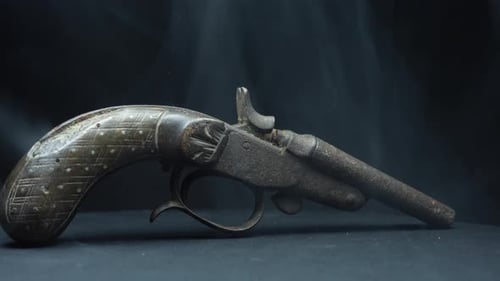 Historic Pistol envolved by white smoke