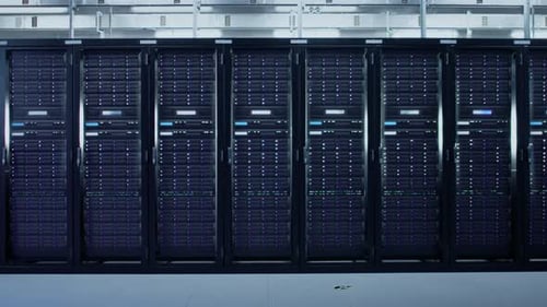 Camera Slide-Trough Shot of a Working Data Center With Rows of Rack Servers. Led Lights Blinking an