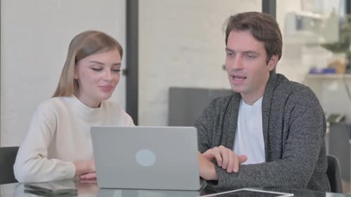Colleagues Participating in Online Video Conference at Table