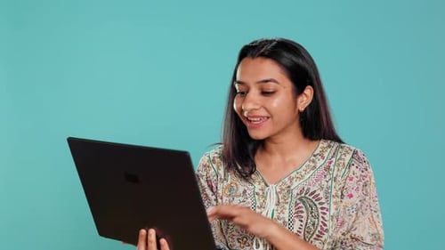 Enthusiastic Woman on Video Call Using Laptop