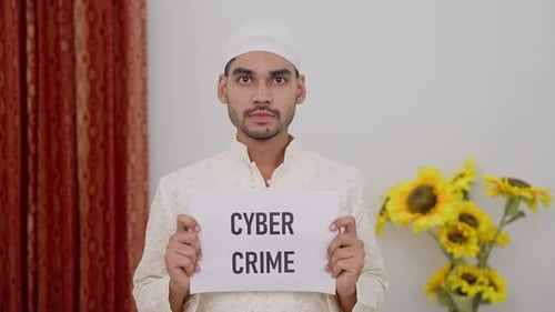 Young Adult Holding Cybercrime Sign Indoors