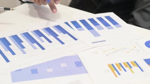 Close up of Business People Discussing Business Report