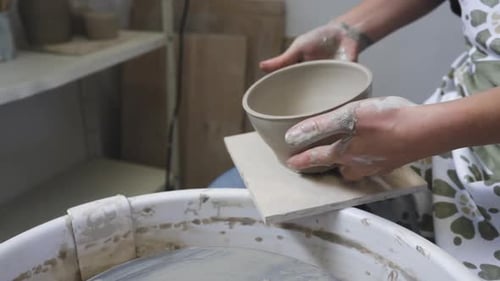 Artist woman in the pottery studio making bowl with her hands, handmade creative artist