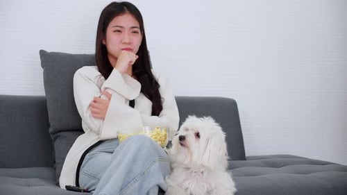 Woman Relaxing at Home with Cute White Dog