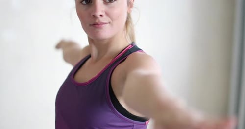 Woman Practicing Yoga Poses on a Blue Mat