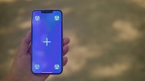 Young Woman Holding Phone Chroma Key Screen in Front of Sand Background Closeup Girl with Green