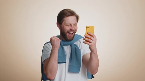 Man Excited About Content on His Phone