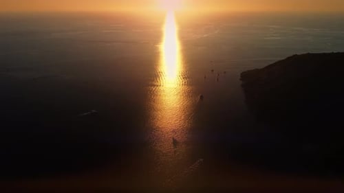 Majestic Sunset Reflecting in the Sea Bay Where Boats and Ships Swimming Near Rock Filmed By Drone
