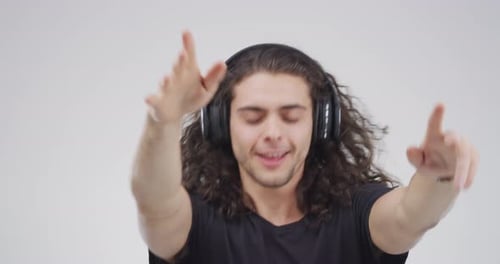 Man with Headphones Listening and Dancing to Music