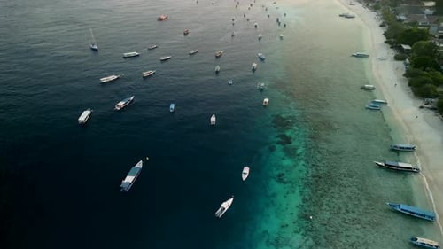 Aerial view of boats on clear water and coastline, Indonesia.