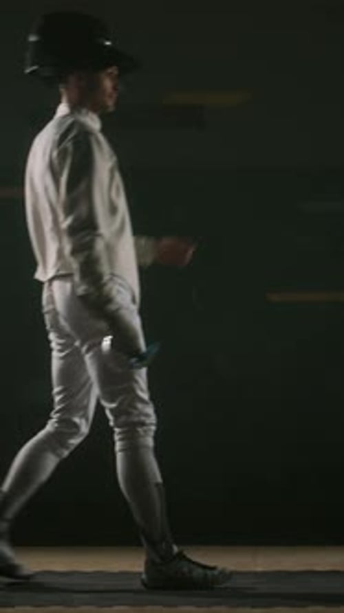 Vertical of Male Fencer Getting Ready to Fight and Taking Starting Pose