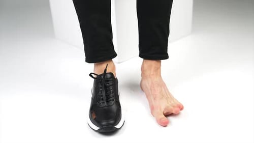One Foot Bare and One with Black Sneaker