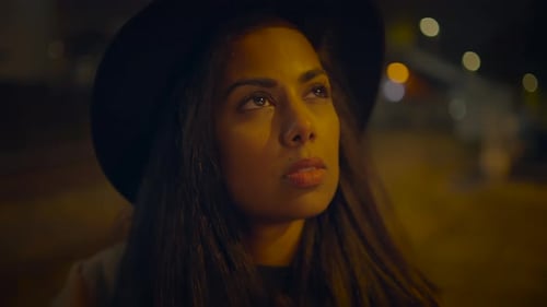 Young Woman Takes Pictures at Night with Camera