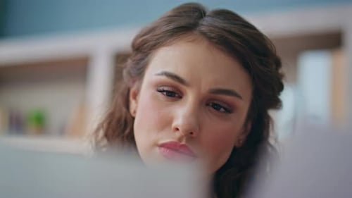 Woman with Curly Hair Looks Down and Up