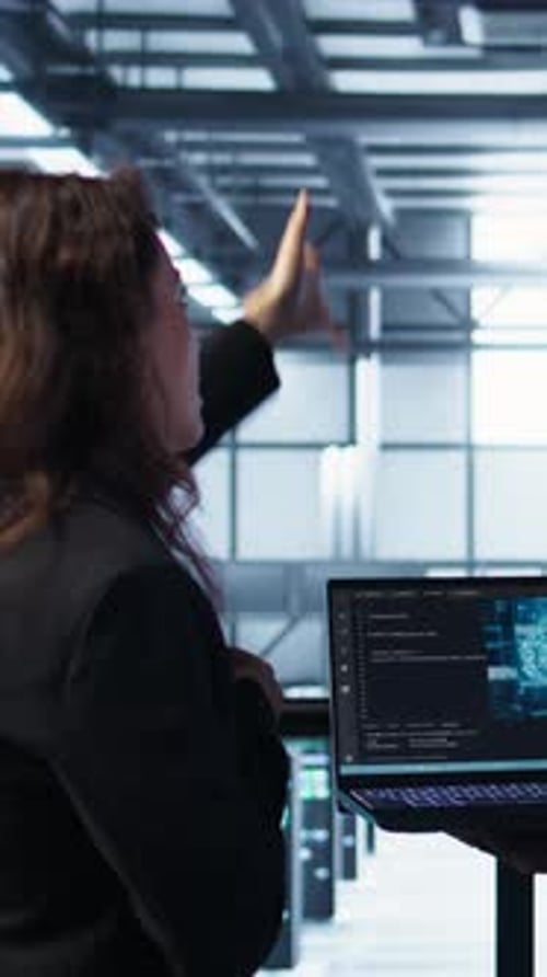 Vertical Video IT Expert Coding on Notebook in Server Room Using Artificial Intelligence