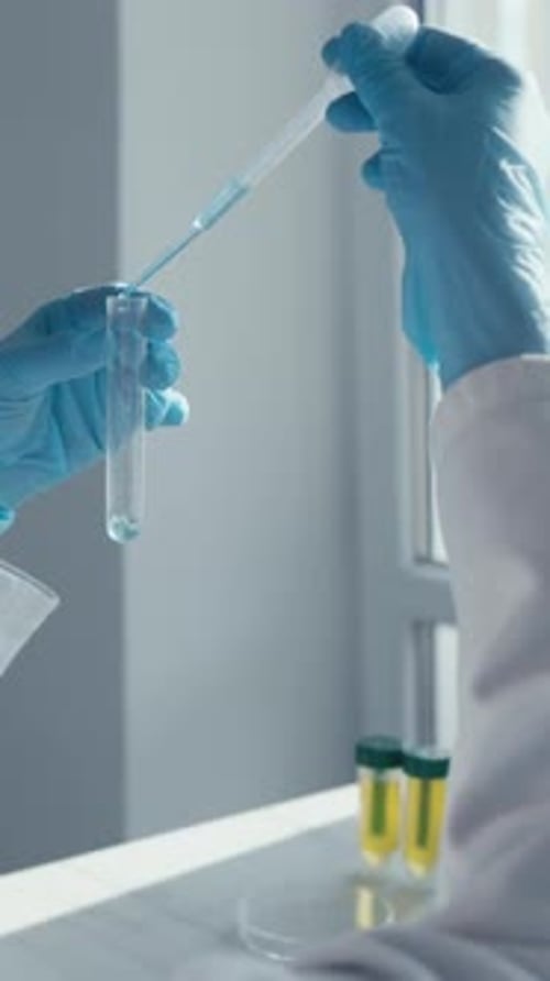 A Diligent Scientist is Conducting a Complex Experiment in a Wellequipped Lab Using a Test Tube for