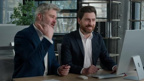 Two Men Celebrate Success in Modern Office